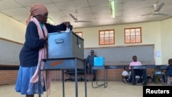 FILE - A woman casts her ballot at Moshupa village, in the Southern District of Botswana, Oct. 23, 2019. 