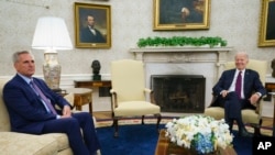 FILE - House Speaker Kevin McCarthy of California, left, listens as President Joe Biden speaks about the debt limit in the Oval Office, May 9, 2023, in Washington.