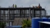 FILE - Construction workers are seen putting up a new development outside Phnom Penh, Cambodia, Aug. 29, 2022. Thousands of Cambodians have become victims of real estate financing schemes and are now struggling to pay back loans.