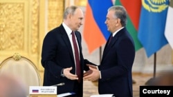 FILE - Uzbek President Shavkat Mirziyoyev talks with Russian leader Vladimir Putin during the Eurasian Economic Union summit, Moscow, May, 8, 2024. (President.uz photo)