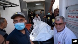 Miembros del grupo de ayuda World Central Kitchen transportan el cuerpo de uno de los seis trabajadores humanitarios extranjeros que murieron en un ataque israelí, en la morgue de un hospital en Rafah, el 3 de abril de 2024.