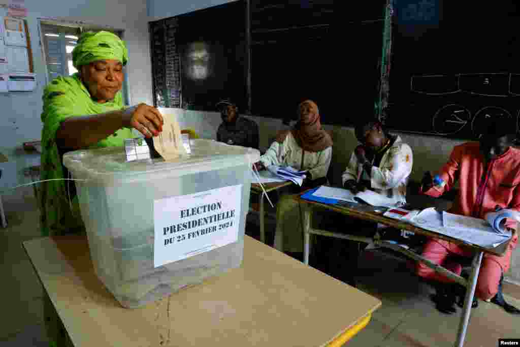 A woman casts her vote during the presidential election at the polling station at Ecole HLM Grand Medine in Dakar, Senegal, March 24, 2024.
