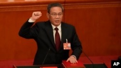 Newly elected Chinese Premier Li Qiang takes his oath during a session of China's National People's Congress (NPC) at the Great Hall of the People in Beijing, March 11, 2023.
