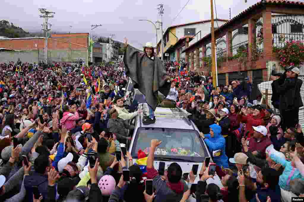 Venezuelan opposition leader Maria Corina Machado wears a traditional garment gifted by her followers as she tours the country despite not being able to run in the upcoming presidential elections, in Merida state, June 25, 2024.