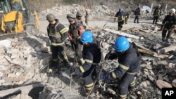 En esta foto divulgada por la Oficina de Prensa de la Presidencia de Ucrania, tabajadores de emergencia buscan víctimas tras un ataque ruso contra la aldea de Hroza, en Ucrania, el 5 de octubre de 2023.
