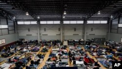 FILE - Ukrainian refugees wait in a gymnasium April 5, 2022, in Tijuana, Mexico.