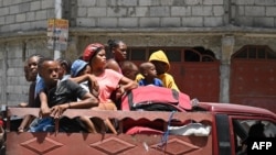 Residents evacuate the Carrefour Feuilles commune in Port-au-Prince, Haiti, on Aug. 15, 2023, as gang violence continues to plague the Haitian capital.