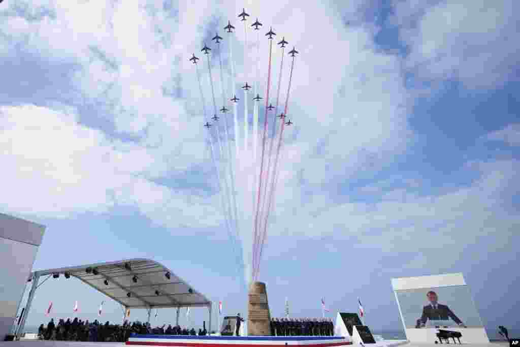 Jets of the Patrouille de France fly over the international ceremony at Omaha Beach in Normandy near Saint-Laurent-sur-Mer. Normandy is hosting various events to officially commemorate the 80th anniversary of the D-Day landings that took place on June 6, 1944. 