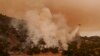 Torrid heat bakes millions in large swaths of US, setting records and fanning wildfires