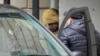 FILE - Wall Street Journal reporter Evan Gershkovich is escorted by security officers from the Lefortovsky Court to a minivan, in Moscow, March 30, 2023.