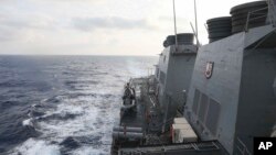 In this photo provided by the U.S. Navy, the Arleigh Burke-class guided-missile destroyer USS Milius (DDG 69) conducts routine underway operations in South China Sea, March 24, 2023.