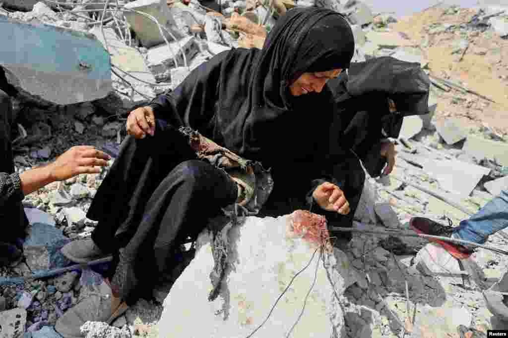 Palestinian sisters Samar and Sahar react as they search for their missing mother Amira Al-Breim at the rubble of a house hit in an Israeli strike, in Khan Younis in the southern Gaza Strip.