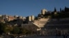 FILE - People walk at the site of the ancient Roman Theater, in Amman, Jordan, March 13, 2024.