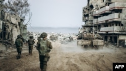 This handout picture released by the Israeli army on Jan. 1, 2024 shows Israeli soldiers operating in the Gaza Strip amid continuing battles between Israel and the Palestinian militant group Hamas. (Photo by Israeli Army / AFP) 