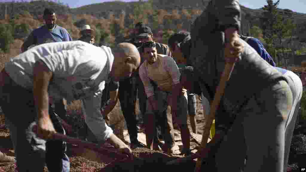 People dig a grave to bury bodies of earthquake victims in Ouargane village, near Marrakech, Morocco, Sept. 9, 2023.