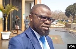 Jeremiah Bamu of Zimbabwe Lawyers for Human Rights talks to reporters outside Harare Magistrates Court on Sept. 5, 2023. He said the arrest of his colleagues "amounts to criminalization of their profession.” (Columbus Mavhunga/VOA)