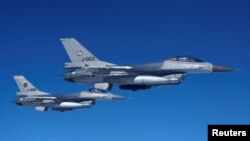 (แฟ้มภาพ) เครื่องบิน F-16 ของกองทัพอากาศเนเธอร์แลนด์ บินเคียงข้างเครื่องบินรบอีกลำที่สาธิตการบินสกัด ให้สื่อมวลชนได้เห็นมาตรการรักษาความปลอดภัยบริเวณน่านฟ้าของพันธมิตรนาโต้ 4 กรกฎาคม 2023 (รอยเตอร์)