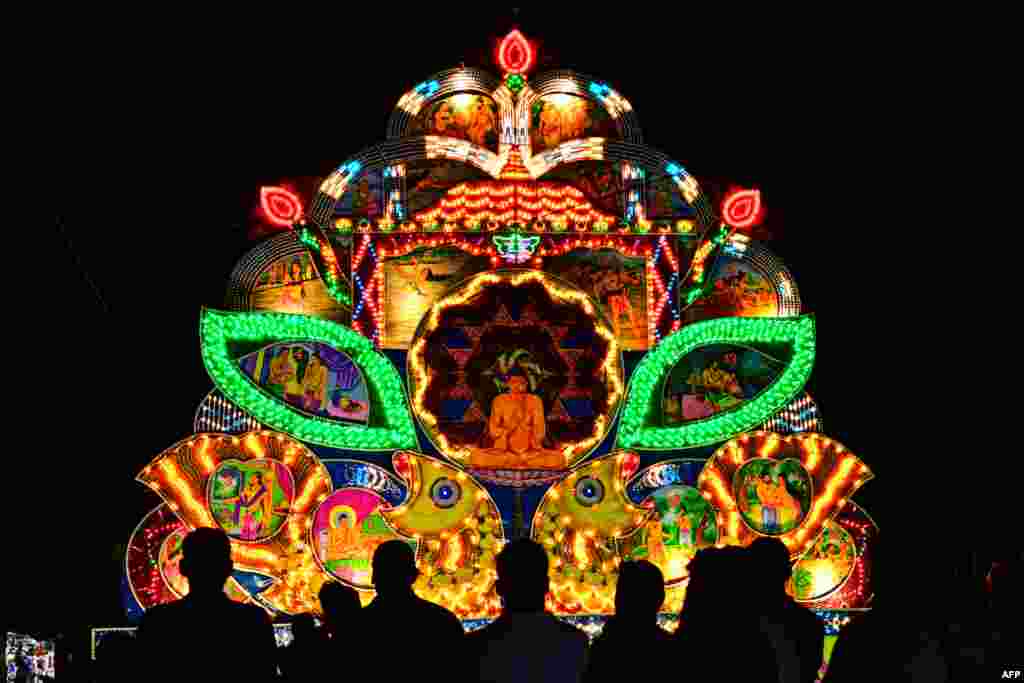 Devotees gather to see illuminated installation on the occasion of 'Vesak festival' which commemorates the birth, enlightenment and death of Buddha, in Colombo, Sri Lanka.