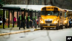 FILE - Students exit a school bus during the first day back to Richneck Elementary School on Jan. 30, 2023, in Newport News, Virginia, after a 6-year-old boy who shot his teacher.