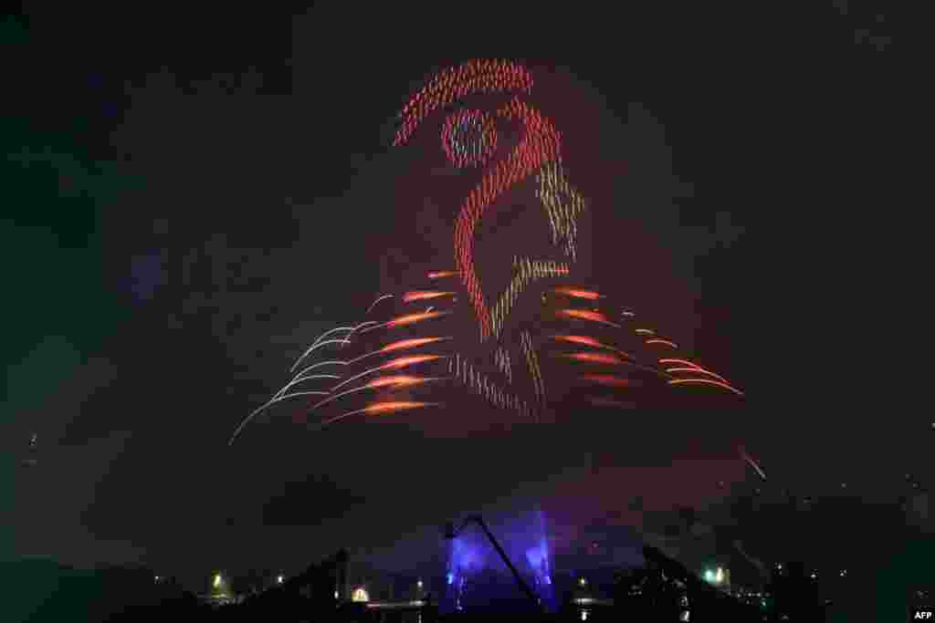 Lights illuminate the sky and shape the face of Marianne, the national personification of the French Republic, during a drone, lights and fireworks show in front of the Eiffel Tower as part of the annual Bastille Day celebrations and ahead of the Paris 2024 Olympic Games in Paris, France, July 14, 2024. 