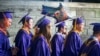 FILE - James Madison University students walk to commencement in Harrisonburg, Va., May 5, 2017. The school is participating in Welcome Corps on Campus, a federal refugee resettlement and education program. (Stephen Swofford/Daily News-Record Via AP)
