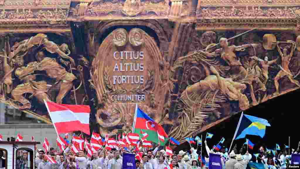 Athletes of Austria, Azerbaijan and Bahamas are seen on their boat at Pont d'Austrerlitz in the river Seine during the opening ceremony of the Paris Olympics, July 26, 2024.