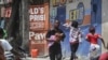 FILE - Residents flee their homes to escape clashes between armed gangs in Port-au-Prince, Haiti, on Aug. 15, 2023.