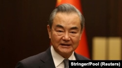 FILE - Chinese Foreign Minister Wang Yi poses as he meets Turkish Foreign Minister Hakan Fidan (not seen) in Ankara, July 26, 2023.