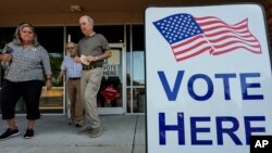 Voters depart an election center during primary voting, in Kennesaw, Georgia, May 21, 2024. 