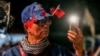 A supporter wears Taiwan national flags on his hat during an election campaign rally in Keelung on Jan. 4, 2024.