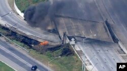 This screen grab from video provided by WPVI-TV/6ABC shows fire and smoke near the collapsed section of I-95 in Philadelphia, June 11, 2023.