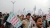 Children hold signs, as supporters of the Houthi rally to denounce the U.S. labeling of Houthis as a 'Specially Designated Global Terrorist' group, in Sanaa, Yemen Jan. 19, 2024.