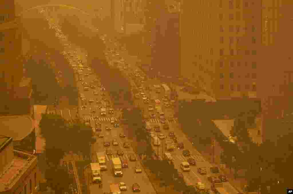 Traffic moves along in New York, June 7, 2023, amidst smokey haze from wildfires in Canada. 