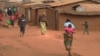FILE - Refugees from various nationalities walk through Dzaleka refugee camp in Dowa District Central region of Malawi on June 20, 2018.