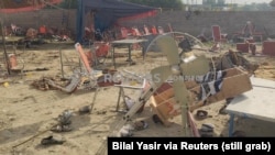 This screen grab taken from a social media video shows the aftermath of an explosion by a suicide bomber in Bajaur district, Pakistan, July 31, 2023. People were said to be sitting under a large tent, listening to a speaker, when the explosives went off. (Bilal Yasir/via Reuters)