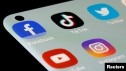 FILE - Facebook, TikTok, Twitter, YouTube and Instagram apps are seen on a smartphone in this illustration taken, July 13, 2021.