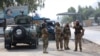 FILE - Taliban security personnel stand guard at the Pakistan-Afghanistan border in Torkham, Afghanistan, Sept. 15, 2023. Two Afghan insurgent groups claim to have killed at least 50 Taliban officials and soldiers during November. 