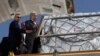 United Nations Secretary-General Antonio Guterres inspects aid for Palestinians, as officials wait to deliver aid to Gaza through the Rafah border crossing between Egypt and the Gaza Strip, at Al Arish airport, in Egypt, Oct. 20, 2023.