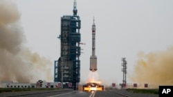 A Long March rocket carrying a crew of Chinese astronauts in a Shenzhou-16 spaceship lifts off at the Jiuquan Satellite Launch Center in northwestern China, Tuesday, May 30, 2023. (AP Photo/Mark Schiefelbein)
