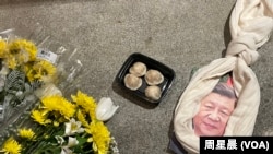 悼念李克強現場，習畫像上套了一條圍巾做的絞索和一盒包子。（周星晨）