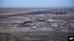 FILE — This Dec. 29, 2019, aerial photo shows Iraq's Ain al-Asad air base in the western Anbar desert. U.S. personnel suffered minor injuries and a member of Iraq's security forces was seriously wounded in an attack on the base Saturday, a U.S. official said. 