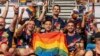 FILE - Participants wave rainbow flags during the opening ceremony of the Gay Games in Hong Kong, Nov. 4, 2023. 