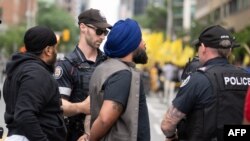 Police arrest a Sikh protester during a demonstration for the independence of Khalistan in front of the Indian Consulate in Toronto, Canada, on July 8, 2023.