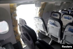 FILE - The fuselage plug area of Alaska Airlines Flight 1282 Boeing 737 Max is seen during its investigation by the National Transportation Safety Board in Portland, Oregon, Jan. 7, 2024. (NTSB/Handout via Reuters)