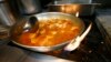 FILE - Shrimp creole is made at Antoine's Restaurant in New Orleans, Sept. 11, 2015.