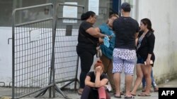 Inmates' relatives wait outside Medicina Legal in Guayaquil, Ecuador, on April 15, 2023, after clashes broke out in the Guayas 1 prison. Another 11 prisoners were injured in another bout of violence in the Guayas 1 prison over the weekend, the prosecutor's office said.