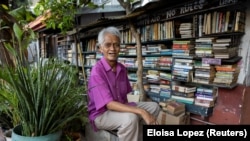 Hernando Guanlao, 72, sits in front of his home library in Makati, a metro area of Manila, Philippines, Feb. 7, 2024. (REUTERS/Eloisa Lopez)