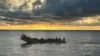 This handout photograph released on Oct. 30, 2023 by the Spanish Maritime Rescue and Safety Society SASEMAR shows migrants aboard a "cayuco" wooden boat, off the coast of the Canary island of Tenerife. 