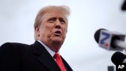 Republican presidential candidate former President Donald Trump speaks with members of the media during a campaign stop in Londonderry, New Hampshire, Jan. 23, 2024. 