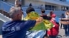 Survivors receive first aid after a rescue operation at the port in Kalamata town, about 240 kilometers (150 miles) southwest of Athens on June 14, 2023. 